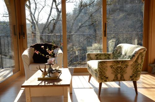 a living room with two chairs and a coffee table at Le Couvent in Saint-Just-sur-Viaur