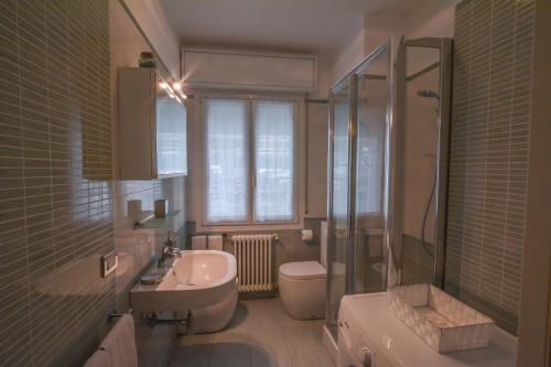a bathroom with a sink and a toilet and a shower at Villa Norma in Milano Marittima