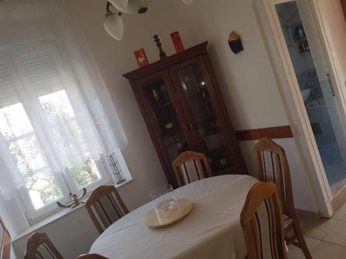 a dining room with a white table and chairs at Villa Royal in Cetinje
