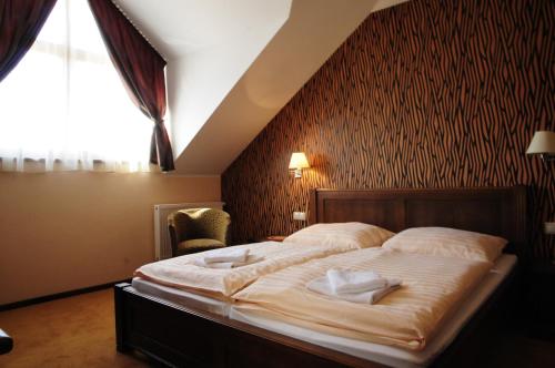 1 dormitorio con 1 cama con 2 toallas en Country Saloon Belá, en Belá