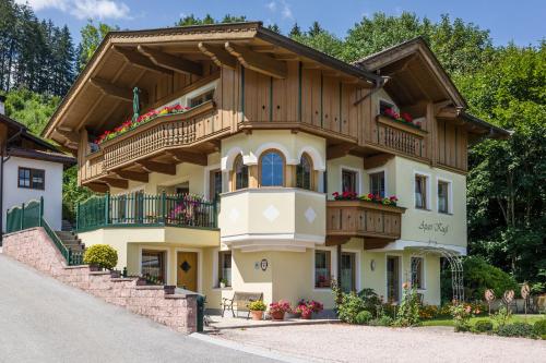 a house with a wooden roof and balcony at Appartement Kugl in Fügen