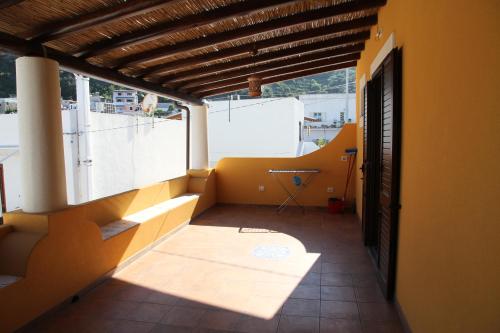 a balcony of a house with yellow walls and a window at Malvasia - Case Vacanza Il Palmento in Canneto