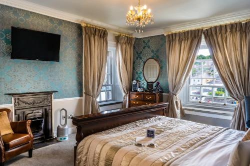 a bedroom with a bed and a television on the wall at The Old Bank Town House in Kinsale