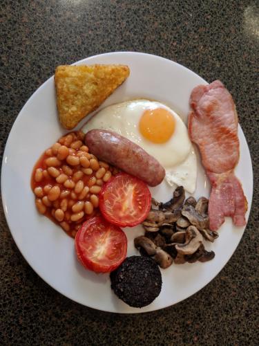 a plate of breakfast food with eggs bacon beans and toast at St Ann’s Guest House in Inverness