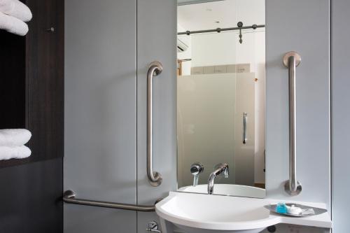 a bathroom with a sink and a mirror at The Z Hotel Tottenham Court Road in London