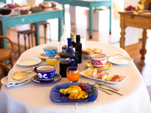 a table with plates of food and drinks on it at Hotel Emilia in Ancona