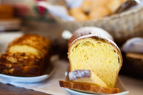 a slice of bread on a plate with other cakes at Hotel Emilia in Ancona