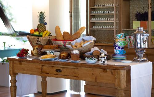a table with baskets of bread and other foods on it at Hotel Emilia in Ancona