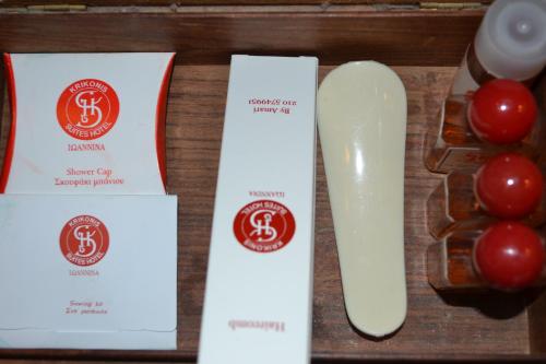 a table with two certificates and a knife and tomatoes at Krikonis Hotel in Ioannina