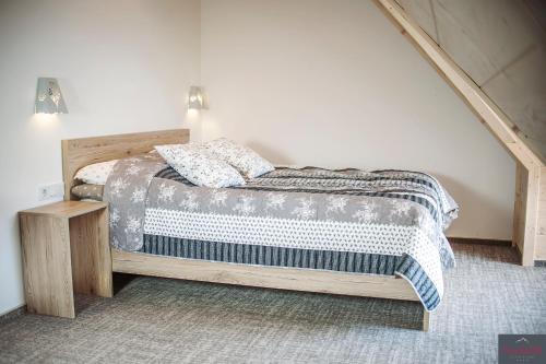 a bedroom with a bed and a staircase at Stachelisko - domki i pokoje in Chochołów