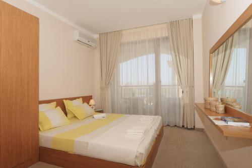 A bed or beds in a room at Bay Apartments Sozopol