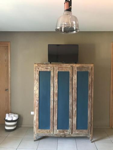 a wooden cabinet with a television on top of it at Doroteo Hotel Boutique in Chihuahua