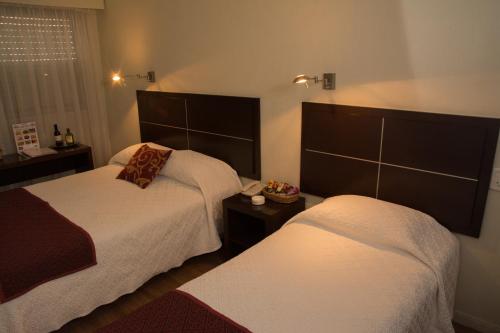a hotel room with two beds at Hotel Europa in Montevideo