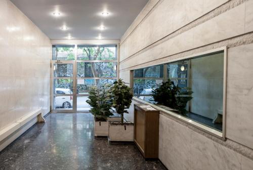 a large aquarium in a room with potted plants at Scent Of Freedom Apartment Renovated in Athens