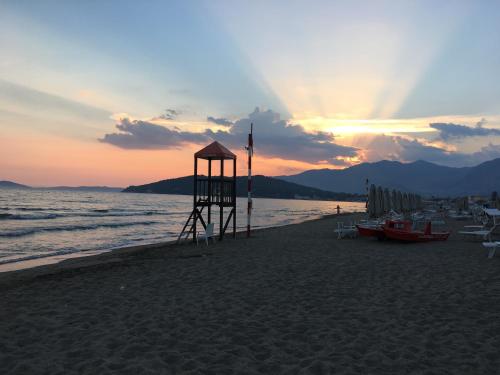 a lifeguard tower on the beach at sunset at Bed&Beach in Scauri