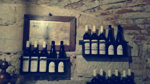 a bunch of bottles of wine hanging on a wall at Chata "Na pohodu" in Chřibská