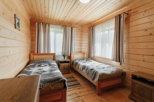 a bedroom with a bed in a wooden room at Hotel "Odessa" in Verkhovyna