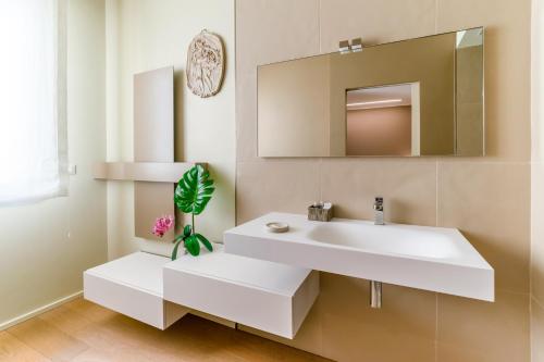 a bathroom with a white sink and a mirror at 051 Boutique in Bologna