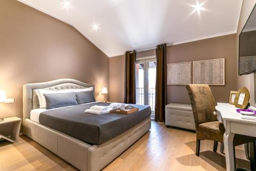 a bedroom with a bed and a table and a desk at 051 Boutique in Bologna