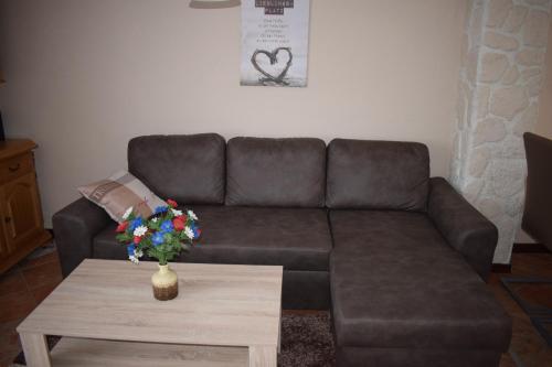 a living room with a couch and a coffee table at Marktstübchen an der schönen Loreley in Bornich
