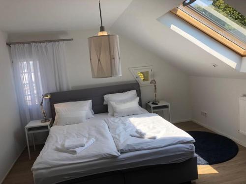 a bedroom with a large bed with white sheets and pillows at ZUM BAHNHÖFLE Restaurant & Hotel - Albbruck Am Rhein in Albbruck