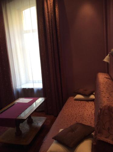 a room with two beds and a window at Pushkin Square in Saint Petersburg