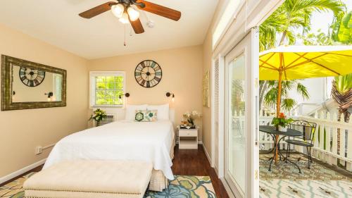 a bedroom with a bed and a balcony at Old Town Manor in Key West