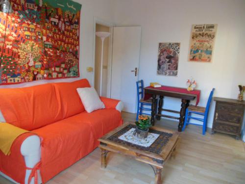 een woonkamer met een oranje bank en een tafel bij DaRiMaPa House in Mondello