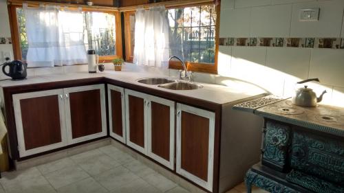 a kitchen with a sink and a counter top at La casa de Hostal del Sol in Rosario