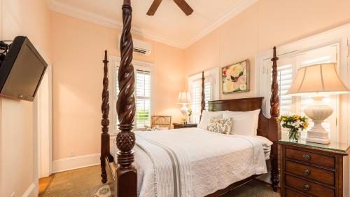 a bedroom with a bed and a television in it at Old Town Manor in Key West