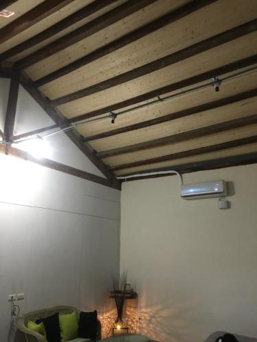a room with a white wall and wooden ceiling at Chen The House in Qingshui