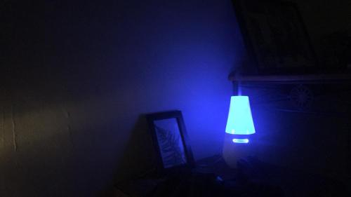 a blue light in a dark room with a mirror at Chen The House in Qingshui