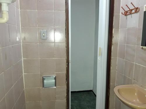 a bathroom with a shower with a toilet and a sink at Paracuru HolaOnda WaveHostel in Paracuru