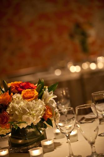 a vase of flowers on a table with wine glasses at Hotel Lombardy in Washington