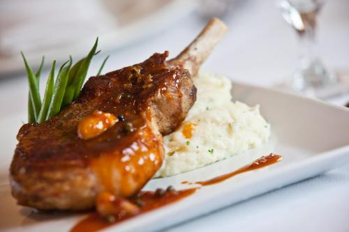 a plate of food with meat and mashed potatoes at Hotel Lombardy in Washington
