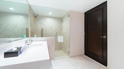 a bathroom with a sink and a large mirror at Barceló Mexico Reforma in Mexico City