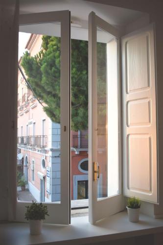 an open window with a view of a building at Il Borgo in Paola