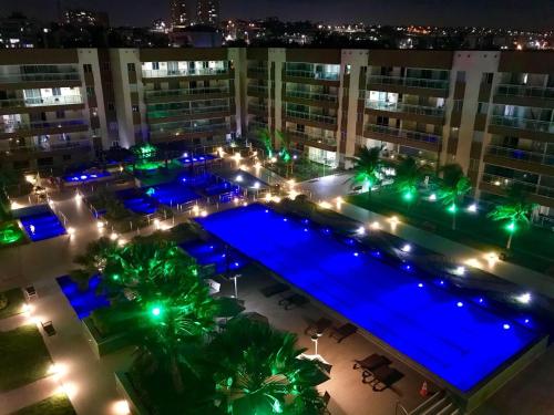 an overhead view of a large building with a pool at night at V G Fun Praia Do Futuro in Fortaleza