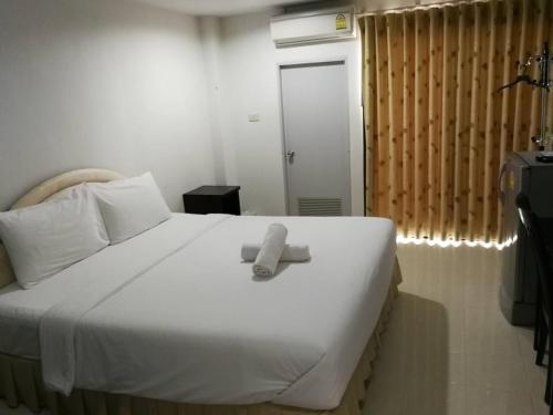 a white bed with a white object on top of it at Ing Loei Place in Loei