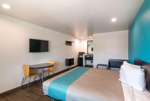 a hotel room with a bed and a table and a kitchen at Motel 6-South El Monte, CA - Los Angeles in South El Monte