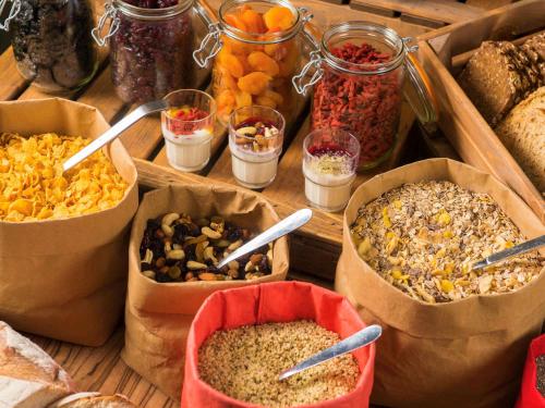 a table topped with containers of different types of food at ibis Antwerpen Centrum in Antwerp