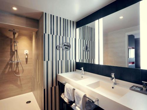 a bathroom with a sink and a mirror at Mercure Orange Centre A7/A9 in Orange
