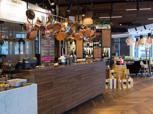 a bar in a restaurant with pots and pans at Mercure Krakow Stare Miasto in Kraków