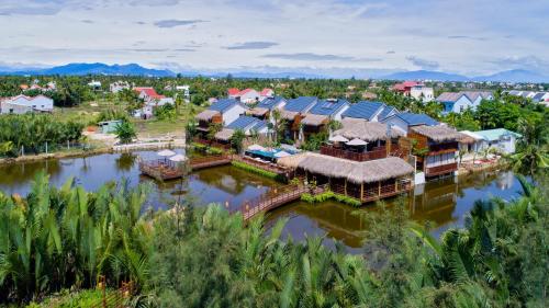 an aerial view of a village on a river at Hoi An Eco Lodge & Spa in Hoi An