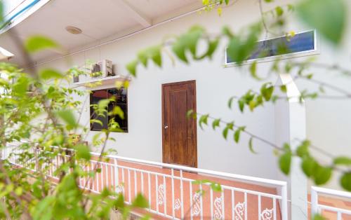a house with a porch with a wooden door at Blossoming Romduol Boutique in Siem Reap