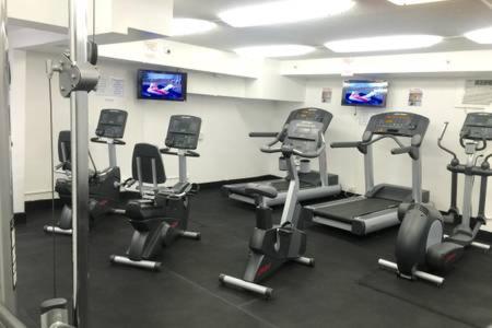 a gym with several exercise bikes in a room at Hawaiian Monarch Upgraded Modern Studio in Honolulu