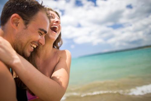 a man and a woman laughing on the beach at BlueBay Villas Doradas Adults Only-All Inclusive in San Felipe de Puerto Plata
