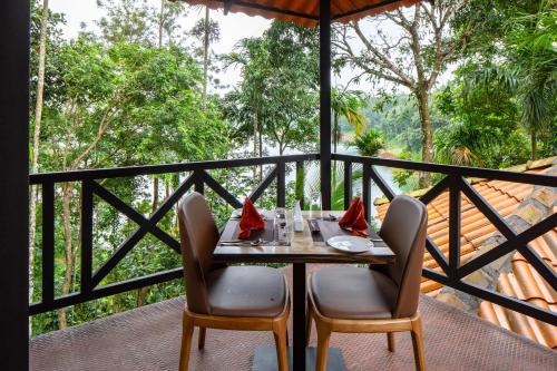 a table and chairs on a balcony with a view at The Serenity Resort in Tariyod