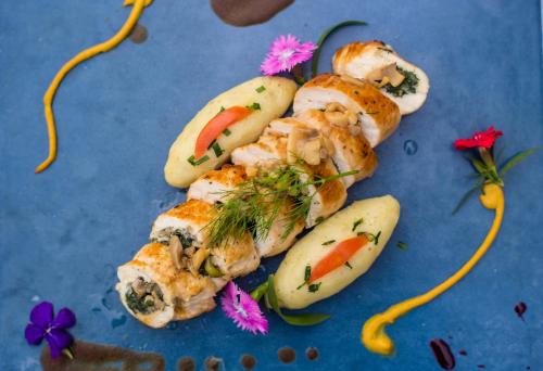 a blue plate with some food with vegetables and bananas at Hotel Queens Park in Pokhara