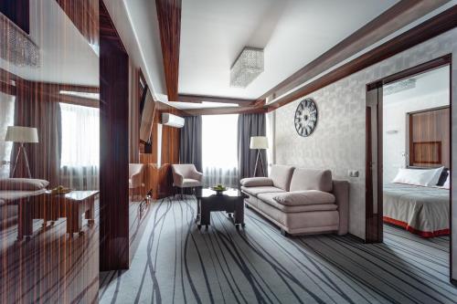 a hotel room with a couch and a bed at Tourist Hotel Complex in Kyiv